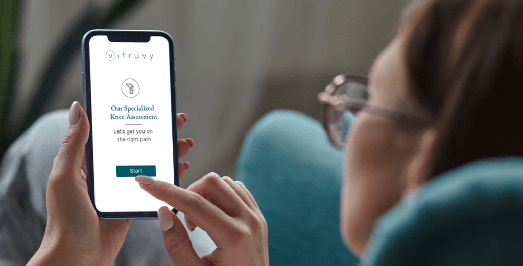 Girl with glasses-on her phone reviewing our specialized knee assessment