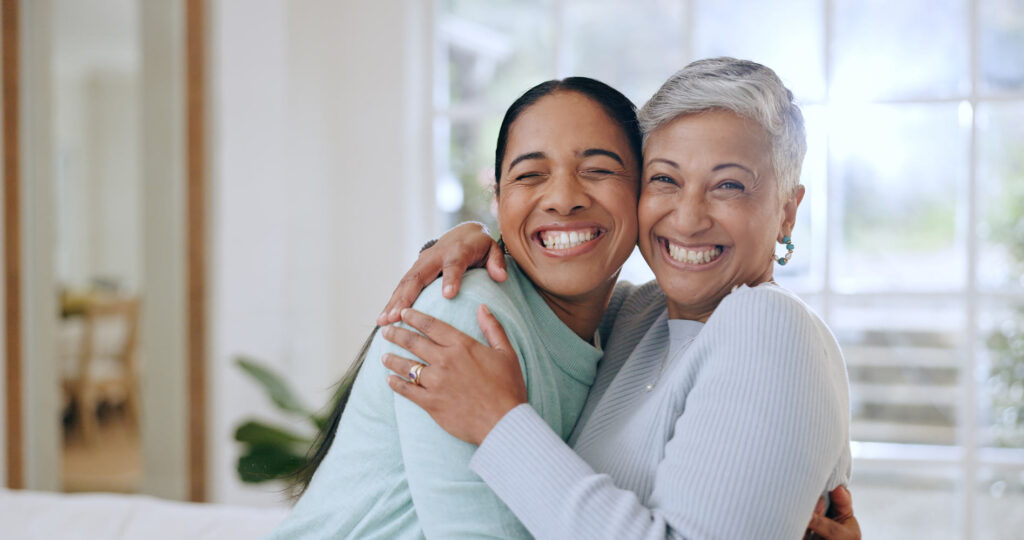 2 women hugging and smiling