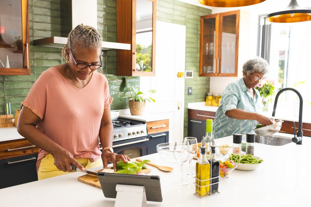 Two mature women cooking