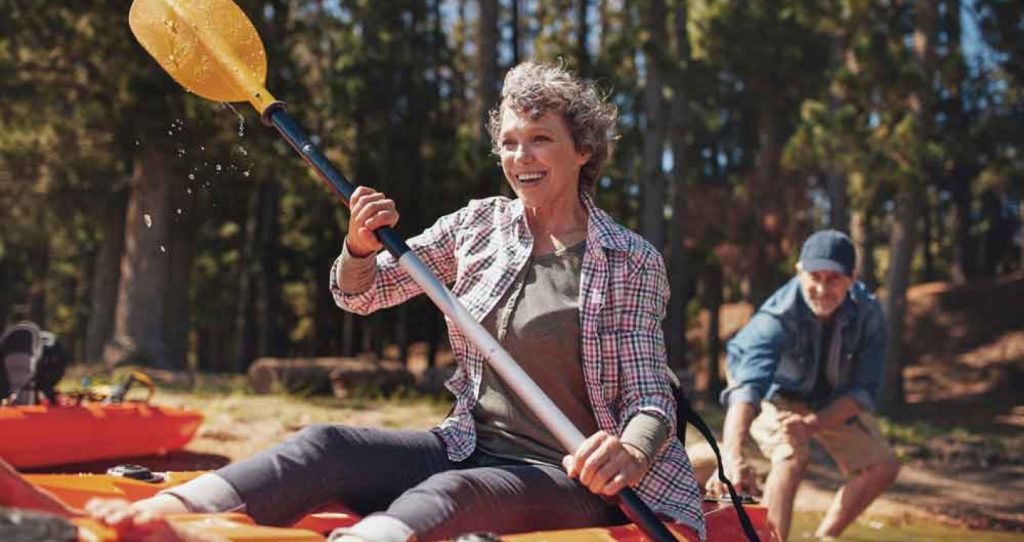 older man and woman on a lake in a kayak